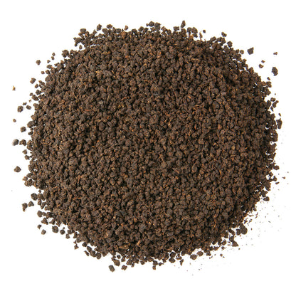 Dry coarse black tea leaves.