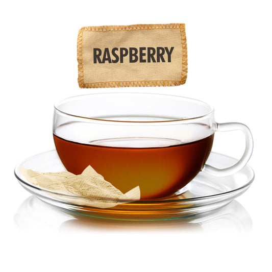 Glass teacup with raspberry-flavored tea and a raspberry-flavored tea bag on a white background