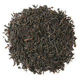 Close-up of Scottish Breakfast dark black tea leaves in a circle on a white background