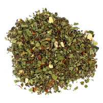 A pile of loose leaf wellness tea with visible pieces of herbs, fruits, and flowers.