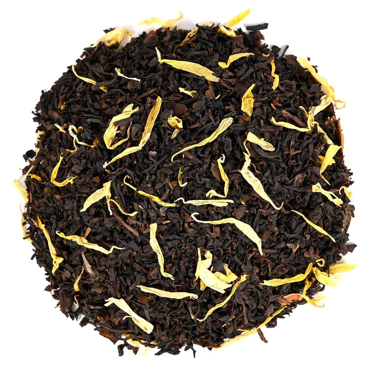 Round tea ball with black tea and gold leaf on white background