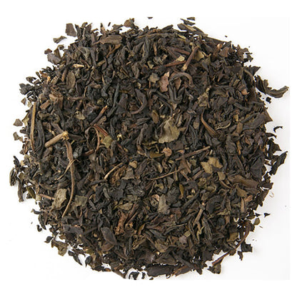 Dry black tea leaves on a white background