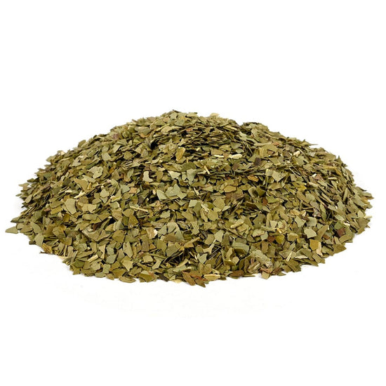 Pile of dried green tea on a white background
