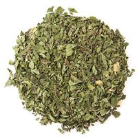 Dried green tea leaves on a white background