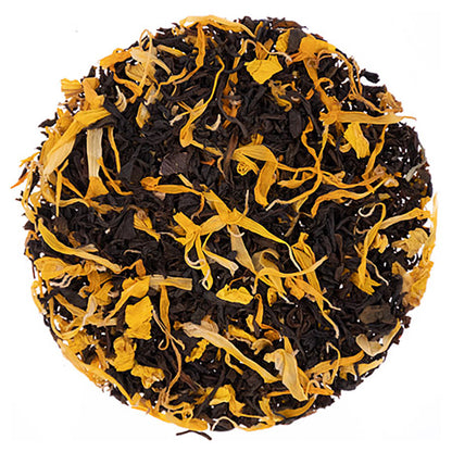 Tea ball with black and yellow tea leaves on a white background