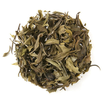 Ball of green tea leaves on a white background