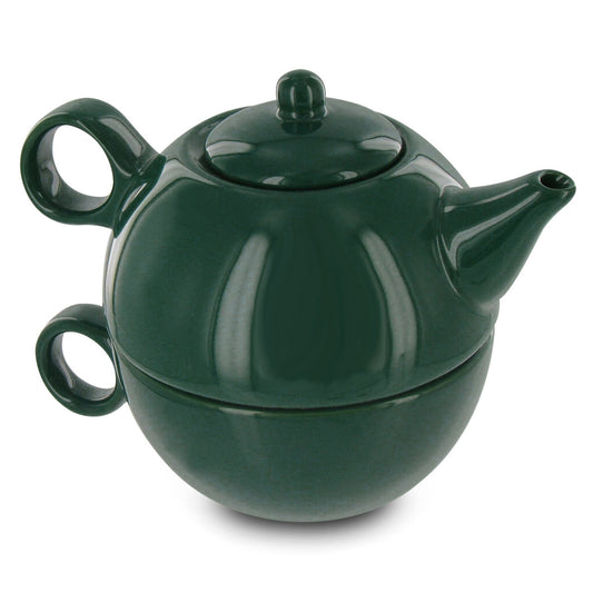 Green teapot stacked on a matching teacup on a white background