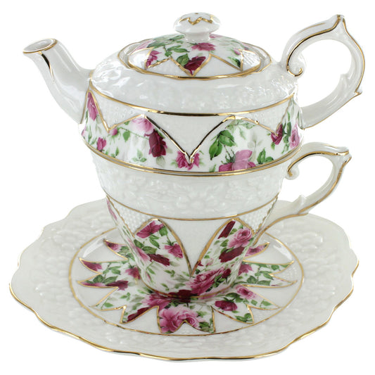 Porcelain teapot, cup, and saucer set with floral design on a white background