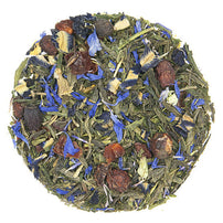Tea ball with green tea leaves, blue flowers, and dried fruit on a white background