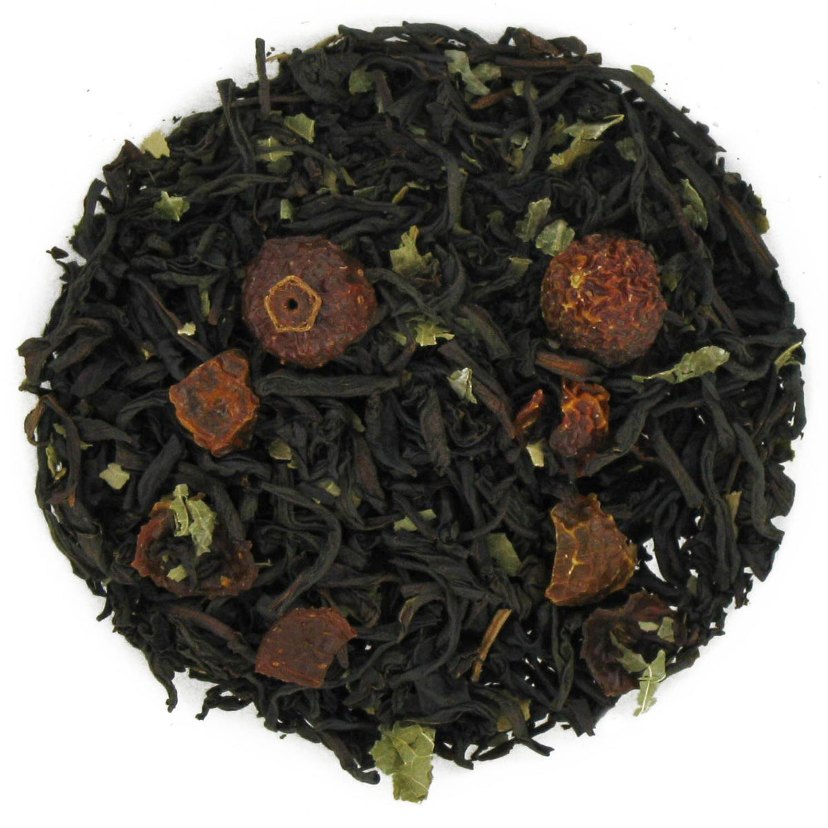 Tea ball with black tea leaves and dried fruits on a white background