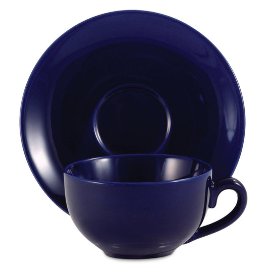 Royal blue ceramic cup and saucer set on a white background
