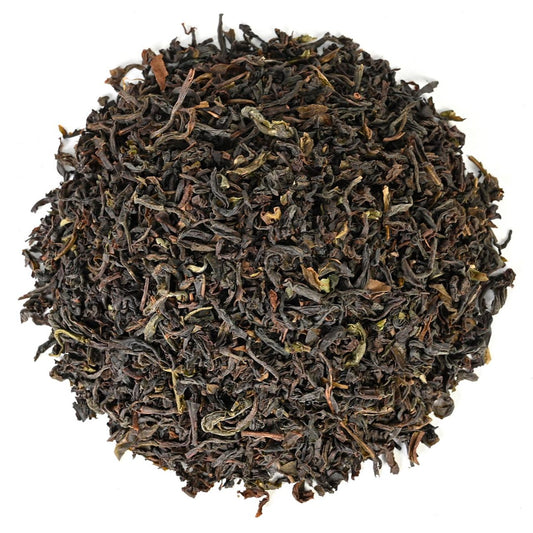 Dry black tea leaves on a white background