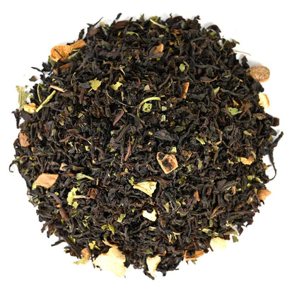 Close-up of loose-leaf black tea leaves on a white background