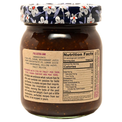 Jar of fig jam with a floral-patterned lid on a white background