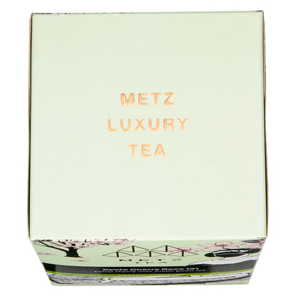 Top of a tea box packaging with floral design and 'Metz Luxury Tea' text on a white background