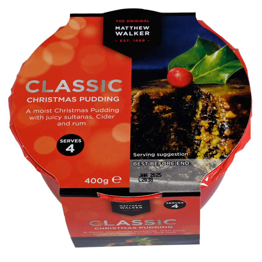 Packaged Christmas pudding with holly leaf and berries on a white background