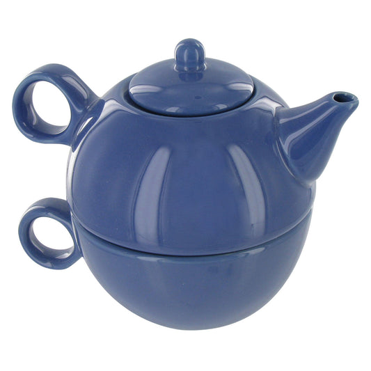 Blue ceramic teapot stacked on top of a matching teacup on a white background