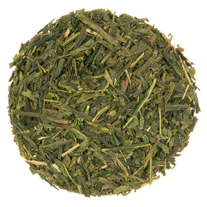 Close up of a circular pile of green tea leaves.