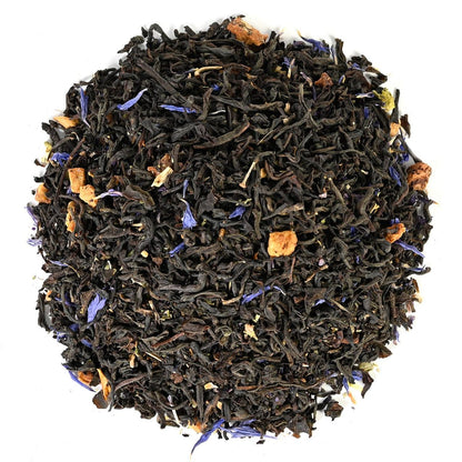 Tea leaves with visible herbs and flowers on a white background