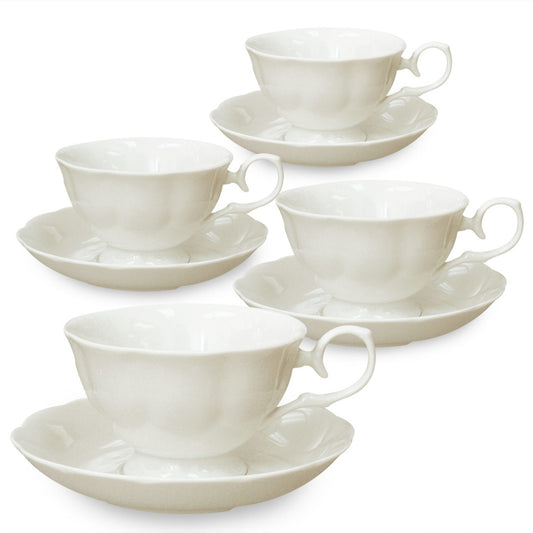 Set of white ceramic teacups and saucers on a white background
