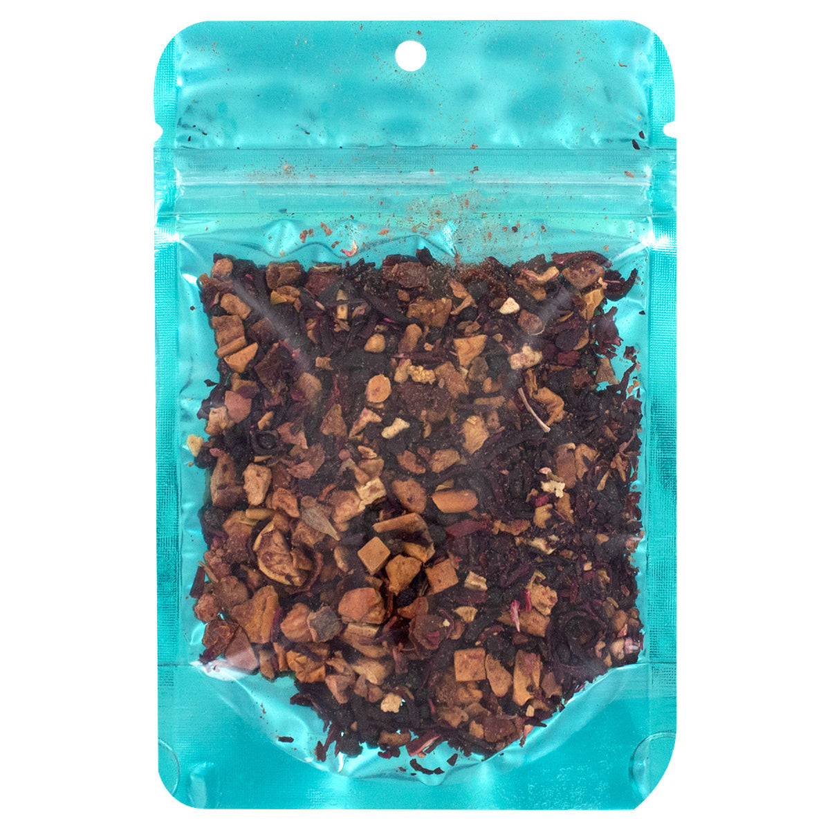 Turquoise packaging with dried tea leaves on a white background