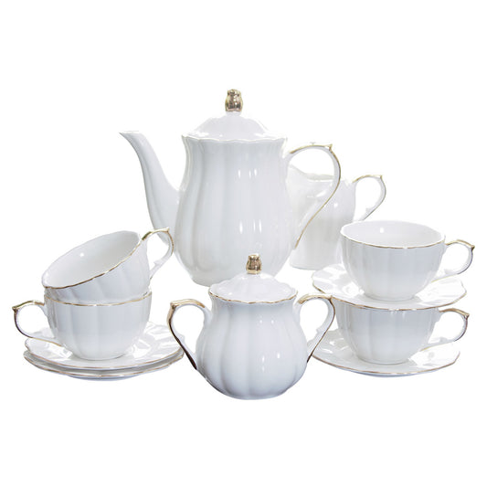 White ceramic tea set with gold accents on a white background