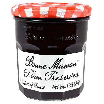Jar of Bonne Maman Plum Preserves with a red and white checkered lid on a white background