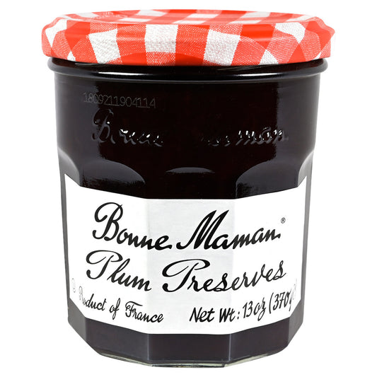 Jar of Bonne Maman Plum Preserves with a red and white checkered lid on a white background
