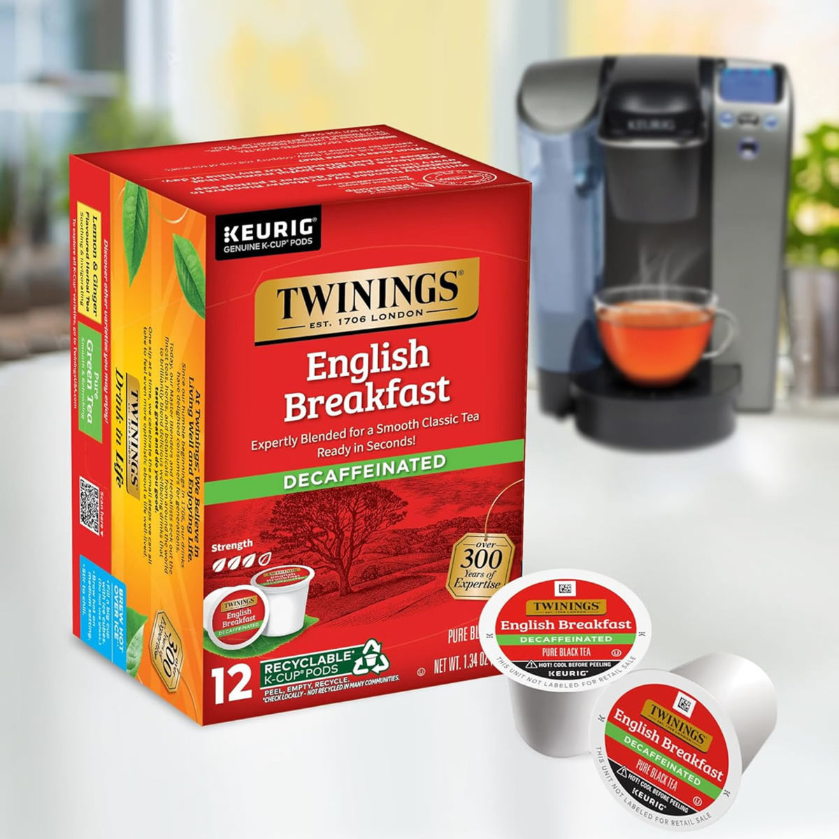 Twinings English Breakfast Decaffeinated tea boxes with K-cups in front of a Keurig machine.