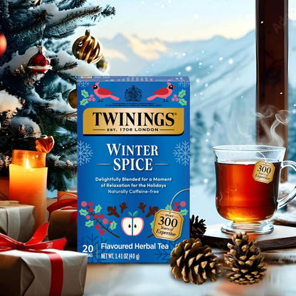 Twinings Winter Spice tea box with a cup of tea and Christmas decorations in the background