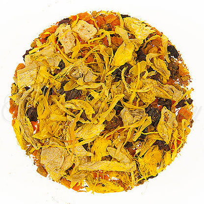 Close-up of a round ball of dried tea leaves, dried yellow flower petals, and dried fruit pieces on a white background