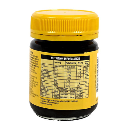 Yellow jar of Vegemite with nutrition label on a white background