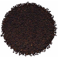 A pile of dry, whole leaf organic Irish breakfast tea.