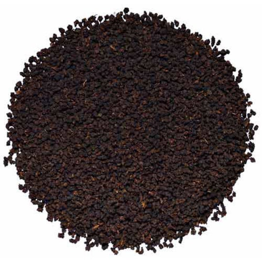 A pile of dry, whole leaf organic Irish breakfast tea.