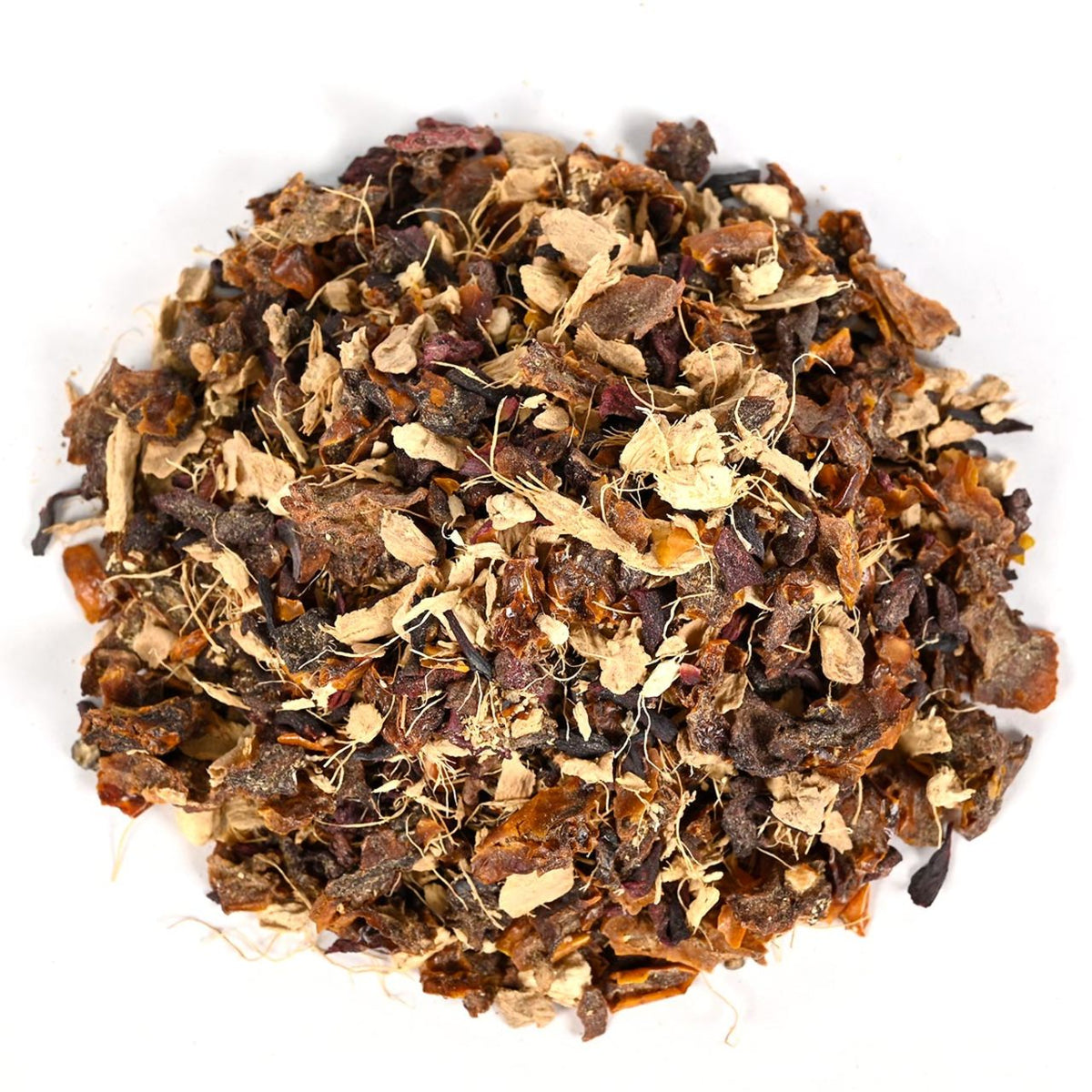 Heap of dried tea leaves of various shades of brown and yellow on a white background