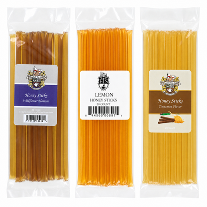Three packages of honey sticks with different flavors including Wildflower Blossom, Lemon, and Cinnamon Flavor all on a white background
