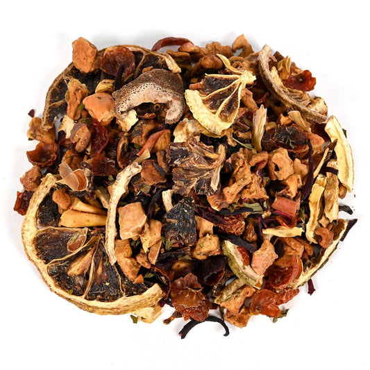 Assorted dried tea leaves intermixed with dried fruit pieces including dried citrus fruit on a white background