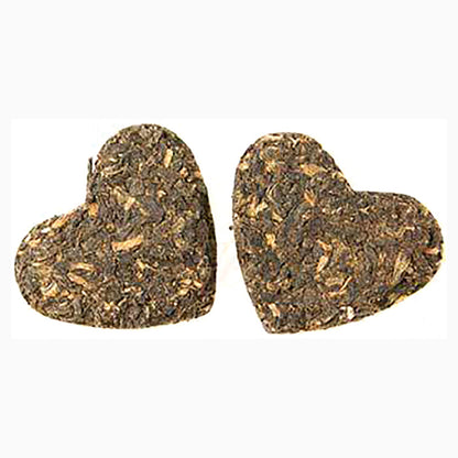 Yunnan tea pressed into two hearts on a white background.