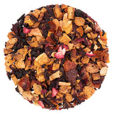 Assorted dried fruit and tea leaves on a white background