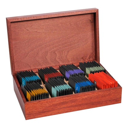 Wooden box opened with assorted Taylors of Harrogate tea bags on a white background