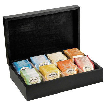 Black wooden tea chest with individually wrapped Twinings teabags on a white background