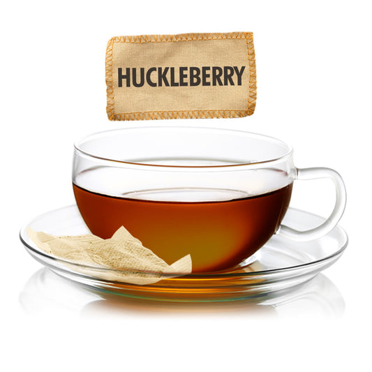 Clear glass teacup with tea and a Huckleberry tea bag on a white background