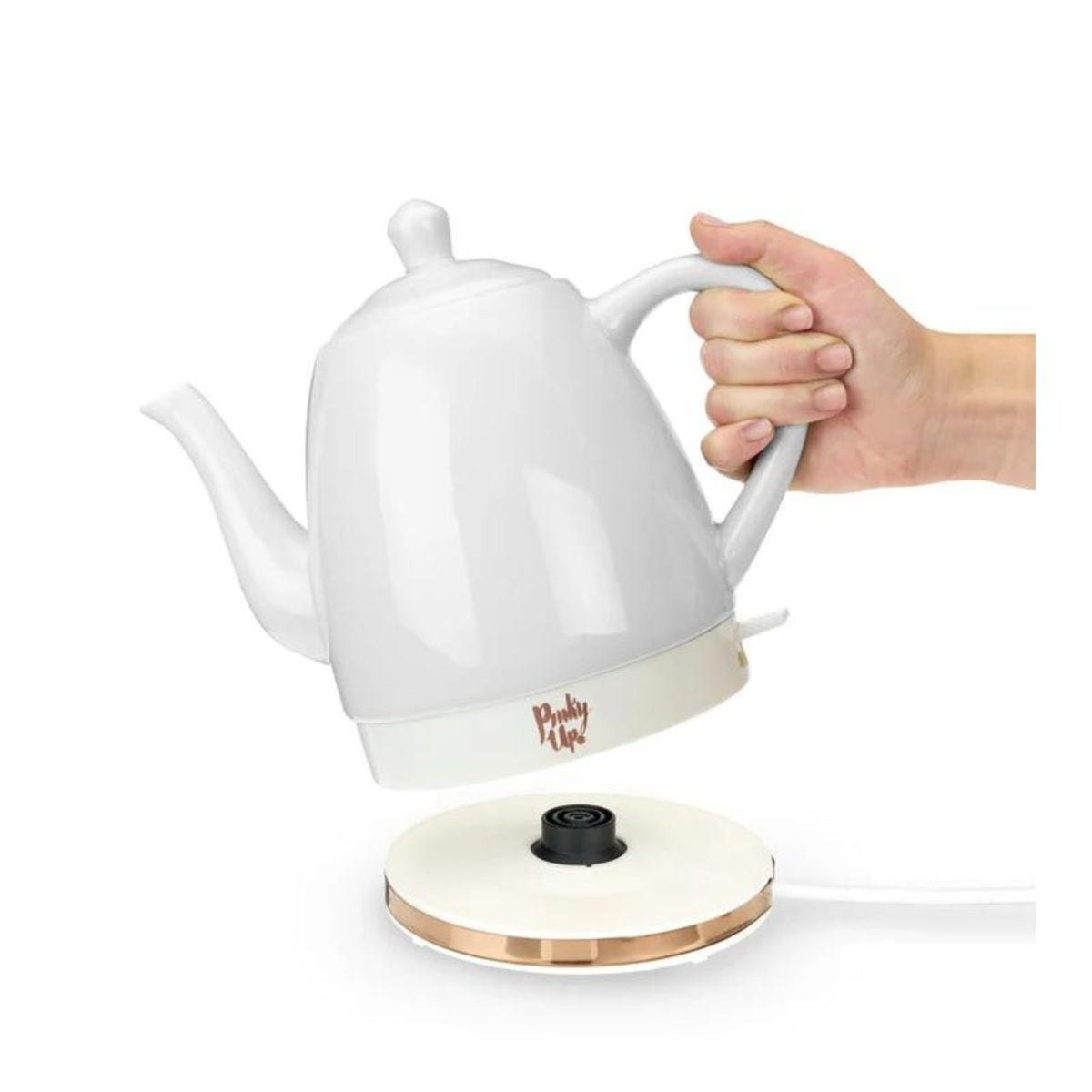 White electric kettle with a hand holding it on a white background