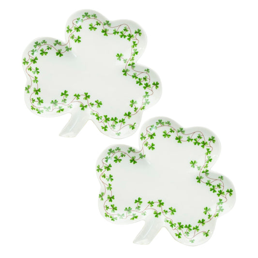 Two white plates shaped like shamrocks with green leaf patterns on a white background