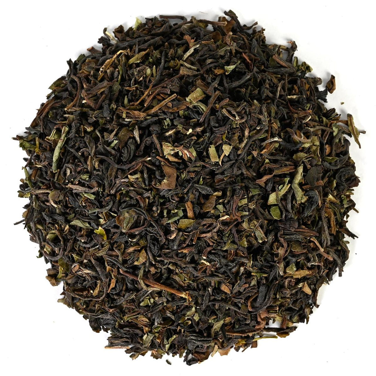 Close-up of black loose-leaf tea on a white background