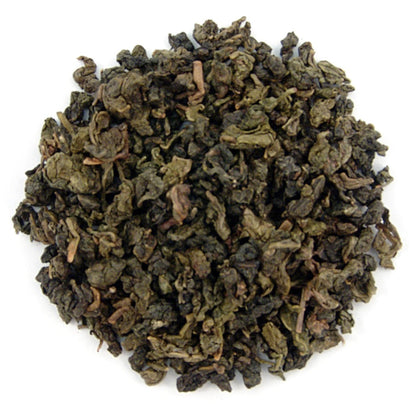 Dry green tea leaves on a white background