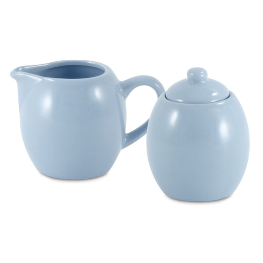 Light blue ceramic creamer and sugar bowl set on a white background