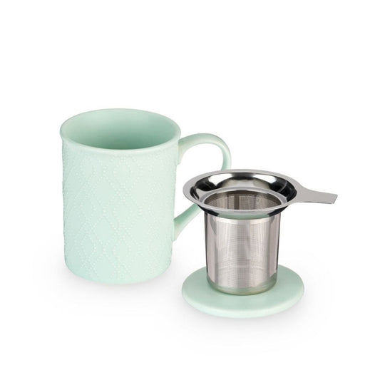 Mint green mug with a metal tea infuser on a white background