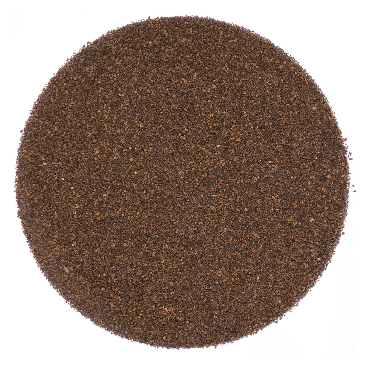 Round pattern of dry dark brown tea leaves on a white background