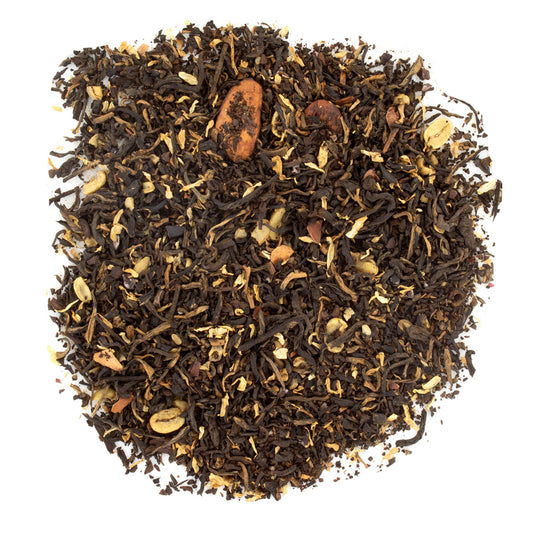 Dry black tea leaves with visible stems on a white background